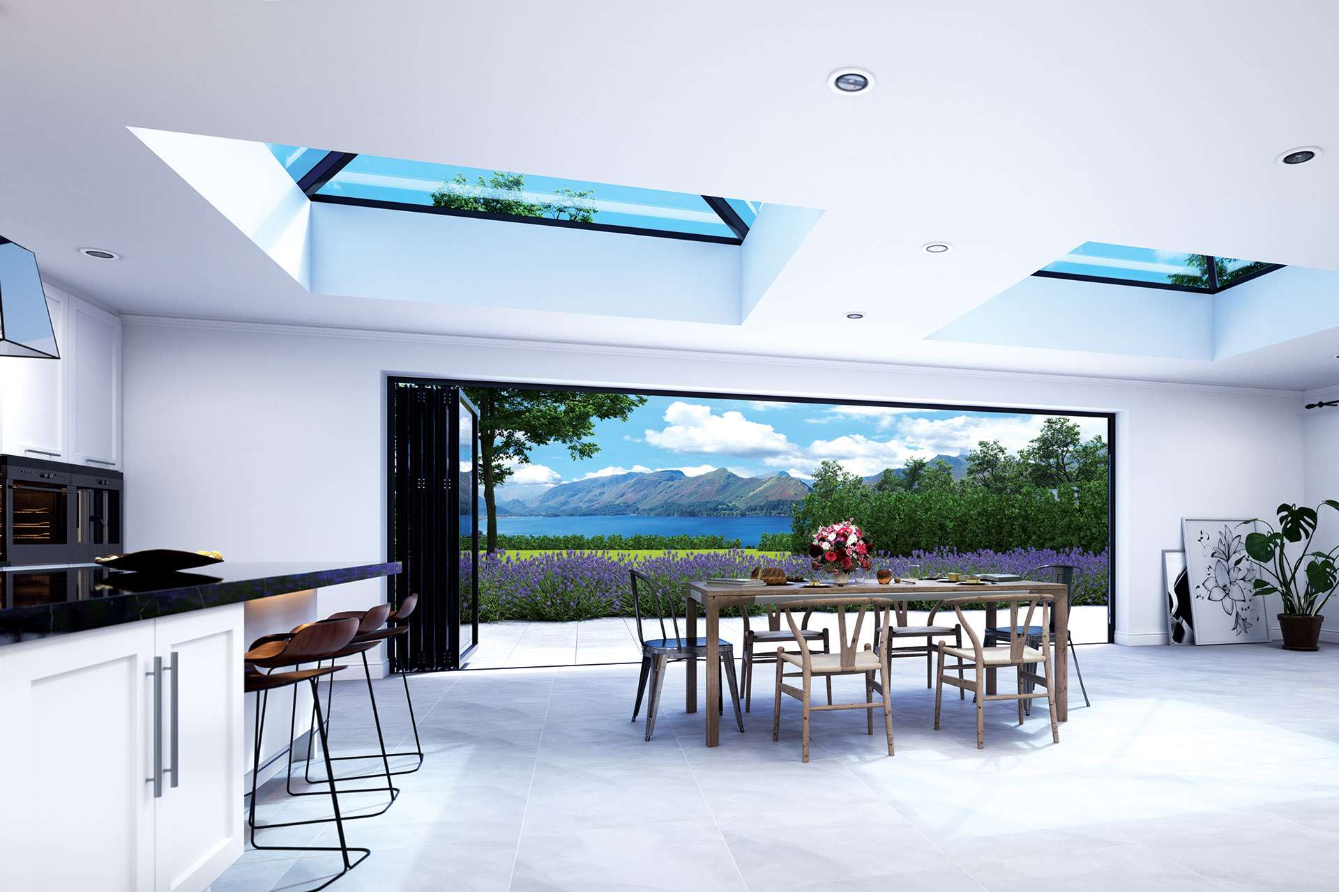 A stylish kitchen with a large window framing a breathtaking view of mountains, a lake, and a lavender field with an outdoor dining area.